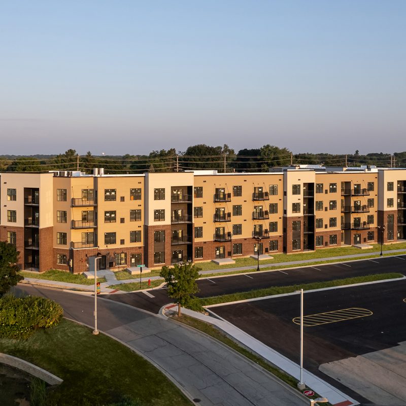 Station 250 apartment complex wide exterior view showing full building facade and surrounding landscape in Mundelein IL