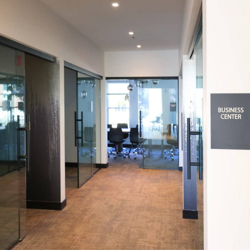 Station 250 business center with orange accent wall, modern seating, and contemporary design elements Mundelein IL